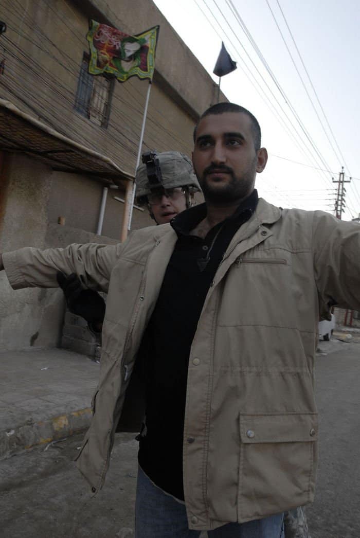 Spc. Mack Pinson, a cavalry scout from Lincoln Park, Mich., assigned to Troop C, 7th Squadron, 10th Cavalry Regiment, 1st Brigade Combat Team, 4ID, MND B, searches an Iraqi citizen caught driving during Iraq Ministry of Interior ban on driving to reinforce security measures in support of Iraq Provincial Elections.