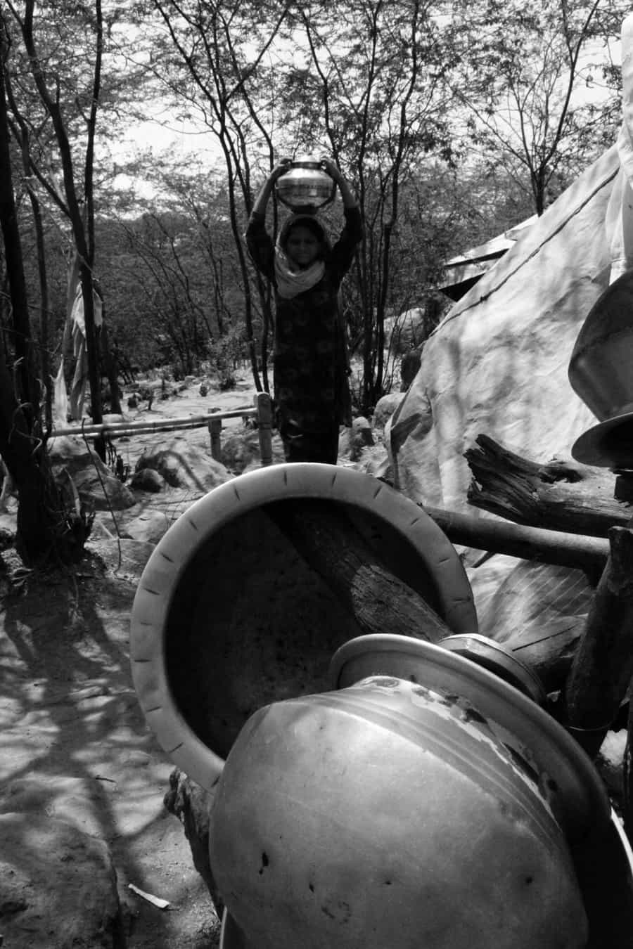 A Pakistani Hindu Refugee Woman Carries Water in a Pot on Her He