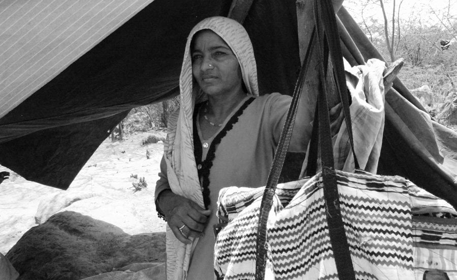 A Pakistani Hindu Refugee Woman Carries Water in a Pot on Her He