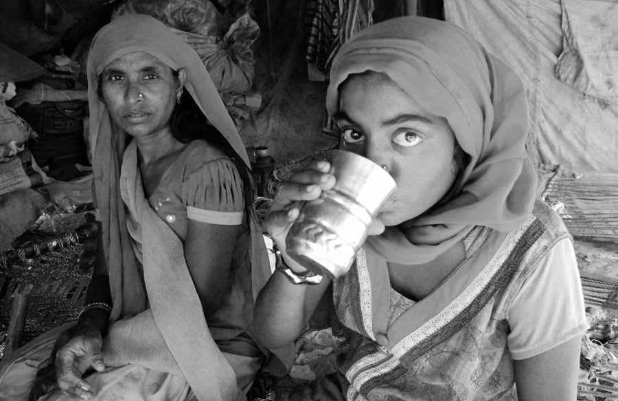 A Pakistani Hindu Refugee Woman Carries Water in a Pot on Her He