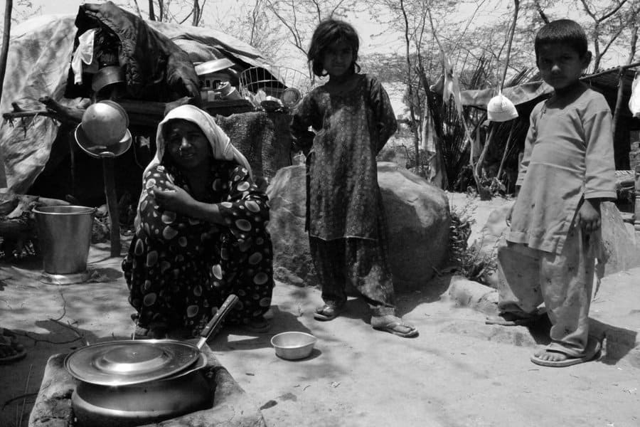 A Pakistani Hindu Refugee Woman Carries Water in a Pot on Her He