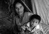 Pakistani Hindu Refugee Woman and Two Small Children In Their Te