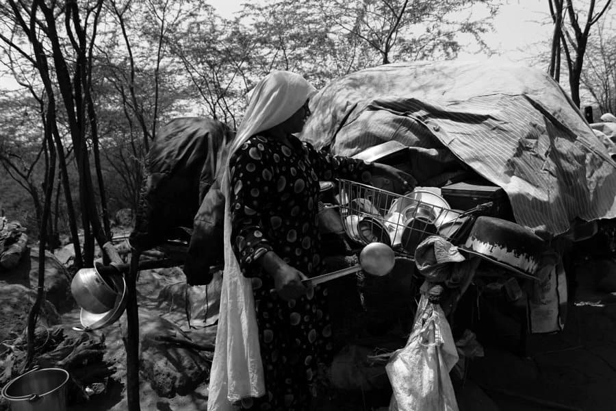A Pakistani Hindu Refugee Woman Carries Water in a Pot on Her He