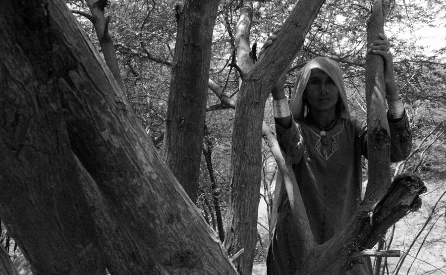 A Pakistani Hindu Refugee Woman Carries Water in a Pot on Her He