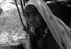 Pakistani Hindu Refugee Woman Washing on a Board With Water From