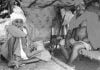 Two Pakistani Hindu Refugee Men Sitting on Cots In a Tent