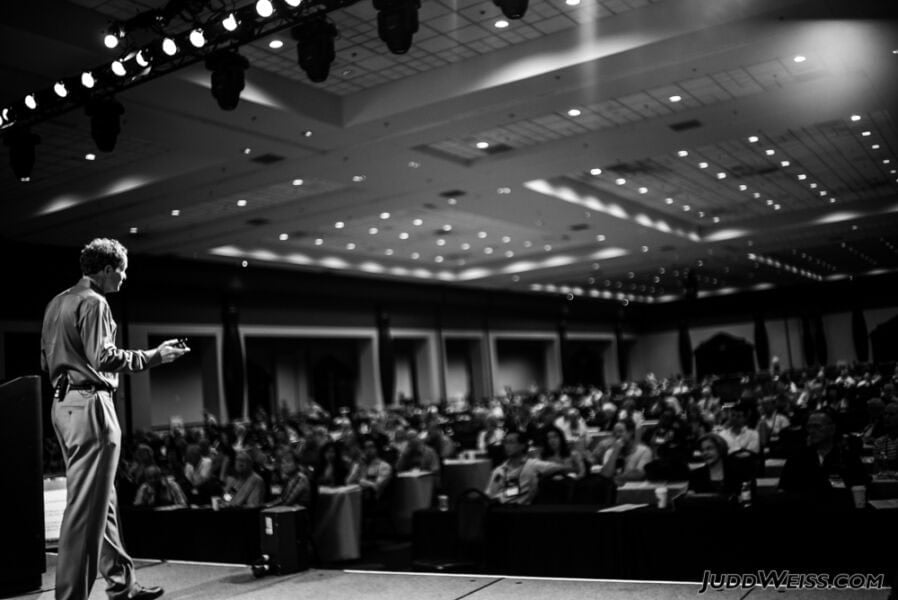 John Mackey speaks on stage before a large audience at FreedomFest.