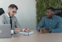 7 Common Factors That Influence Settlement Values Photo by Tima Miroshnichenko: https://www.pexels.com/photo/man-in-professional-clothing-reading-a-resume-5439436/