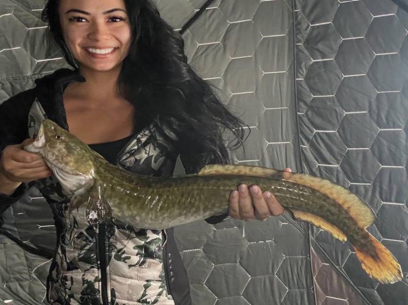 A burbot pulled through the ice, a fish most out-of-state visitors have never heard of.