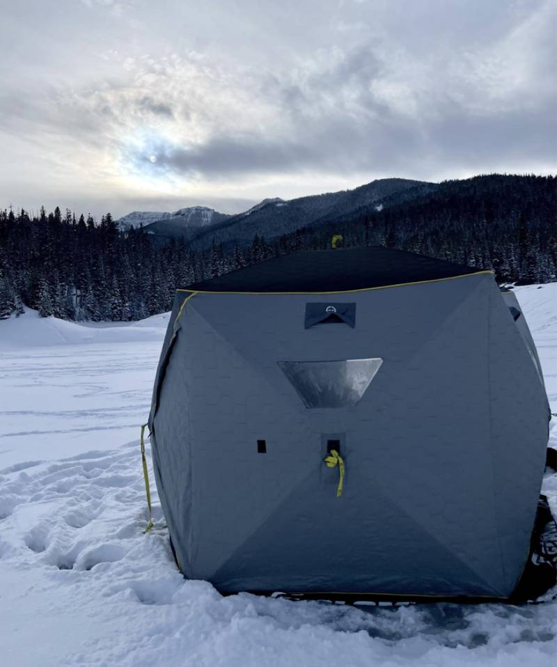 The shelter goes up before the light does. A quiet room in the middle of a mountain range.