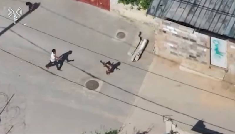 The Real Gaza – Not NAZA - Story 3 Child carrying a weapon while an adult follows behind in Gaza footage